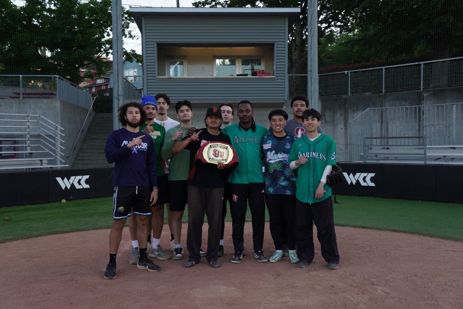 Our group on a ball field with a championship belt