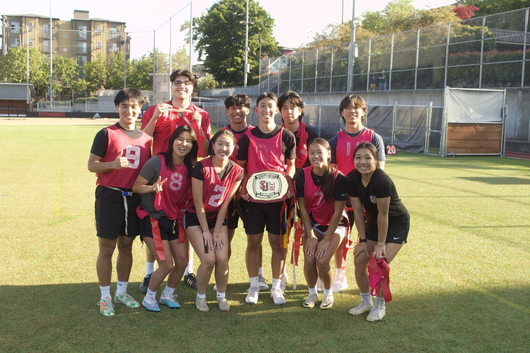 My intramural team in red jerseys with a championship belt