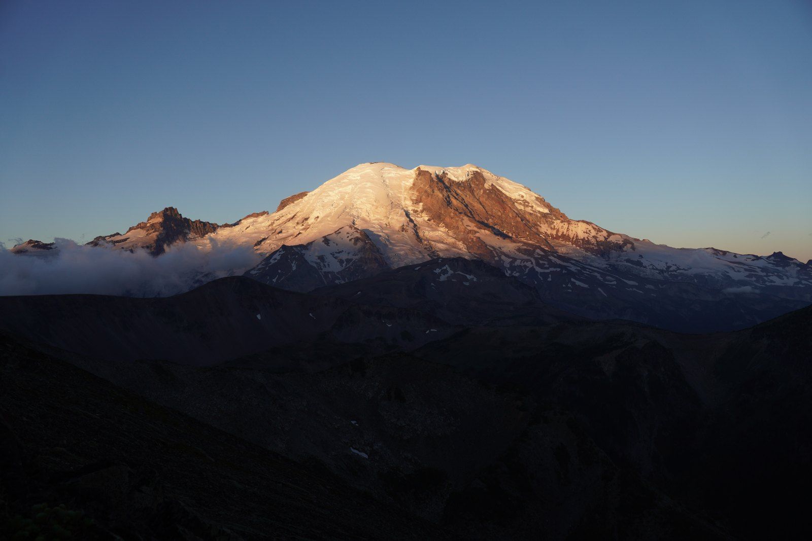 Snow-covered mountain in warm evening light
