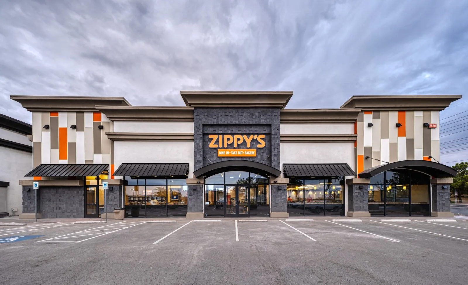 Zippy's restaurant on South Eastern Avenue in Las Vegas, an orange and grey building with a lit Zippy's sign reading dine in, take out, bakery